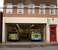 Lewisburg VFD with an open garage showing two fire trucks